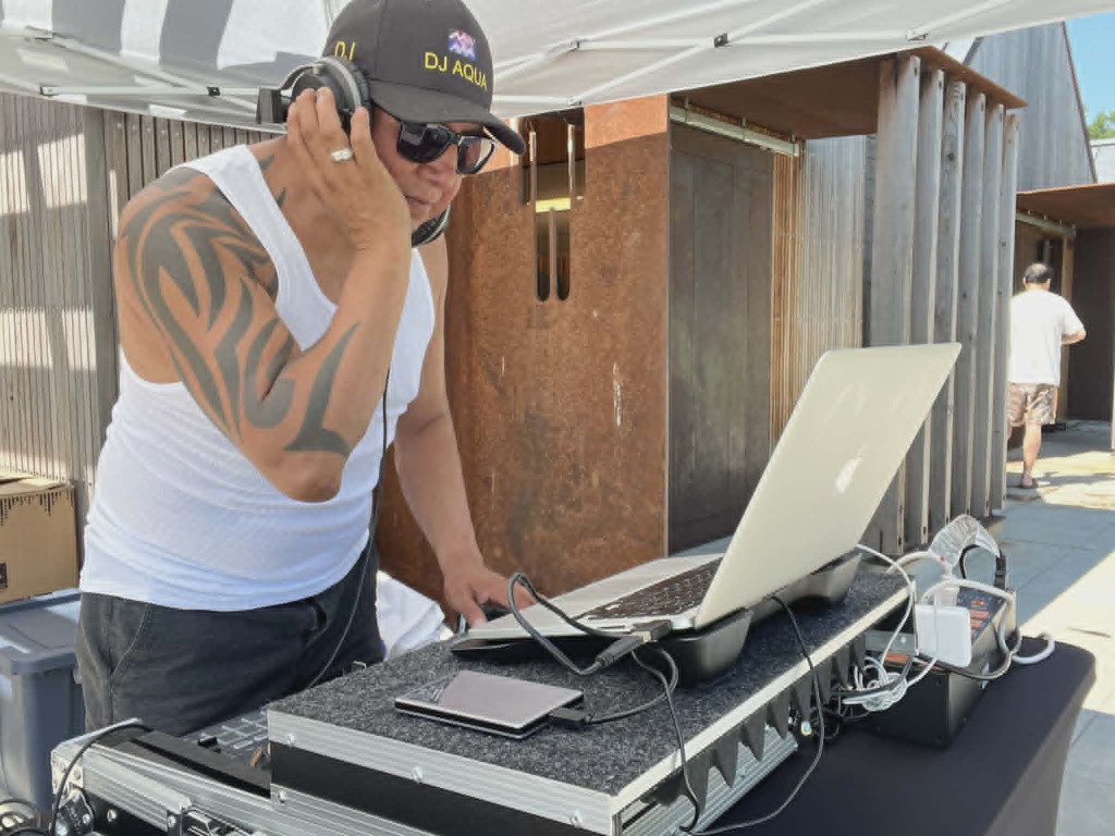 DJ Aqua mixing at an outdoor event
